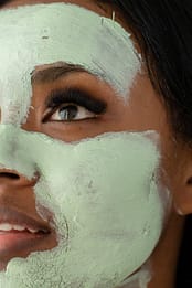 anonymous black woman with clay mask